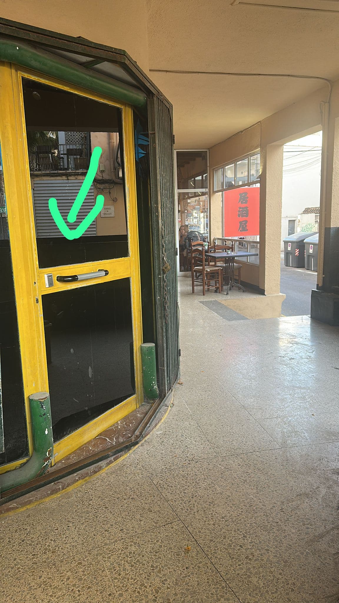 Yellow-green entrance door with green check mark